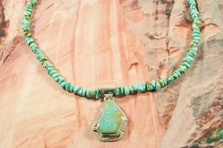 Genuine Number 8 Mine Turquoise set in Sterling Silver Pendant on a Number 8 Mine Turquoise Necklace. Sterling Silver Cones and Clasp. Created by Navajo Artist Phillip Sanchez. Signed. The Number 8 mine is located in Eureka County Nevada. Since 1976 there has been no Number 8 Turquoise mined. There is however, an existing stock pile that Mr. Dowell Ward, the last owner of the Number 8 mine, had stocked away for later sorting. The Turquoise is a collector's item--because once the reserve is gone there will be no more material released onto the market. The Gold Mining Company owns the claim to the Number 8 mine and it has been swallowed up by the gold mining operations. This is some of the last Number 8 Turquoise to be had and will be a great addition to your collection. 